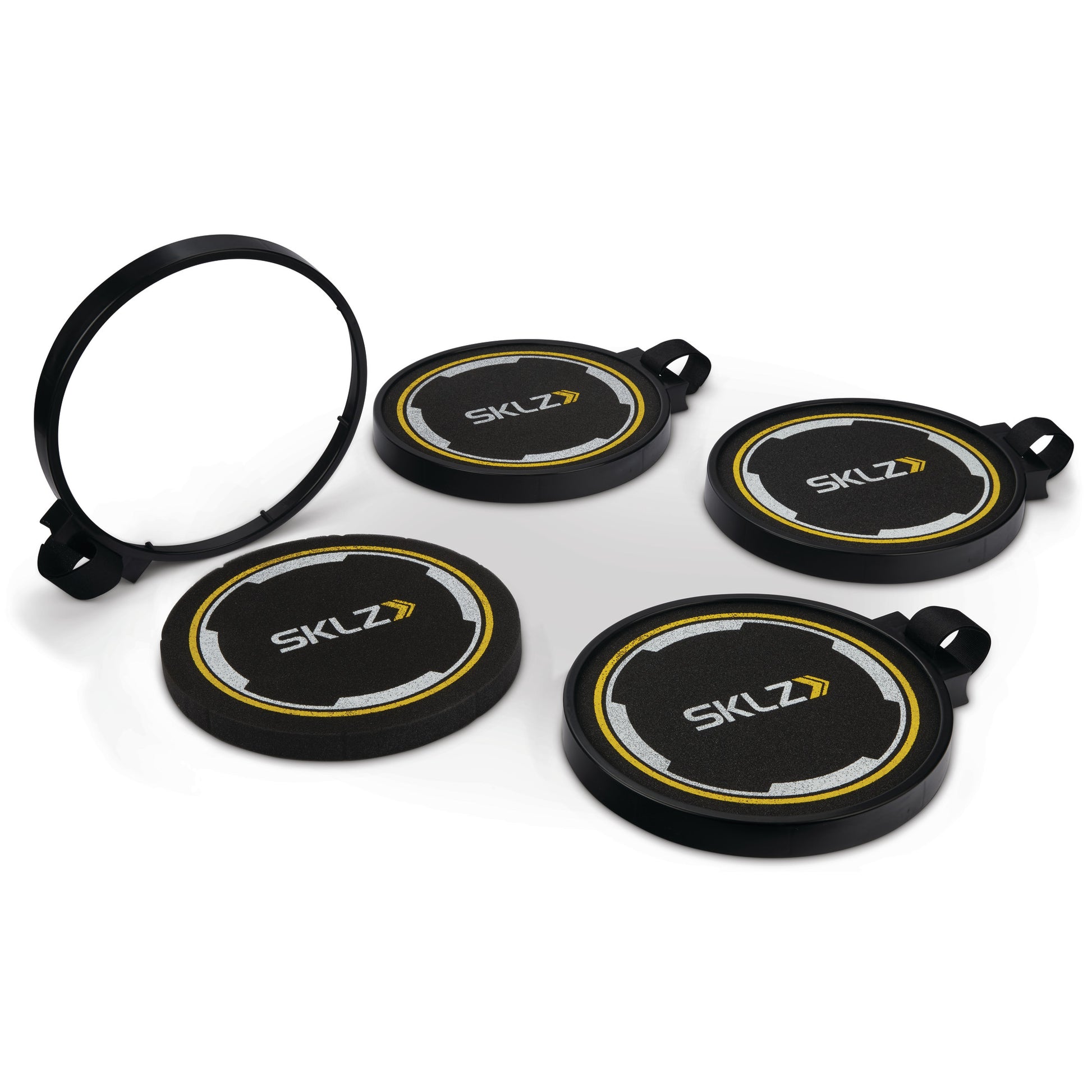 The set of four indexed ski pole guards is arranged on a white surface with a spare part in the background