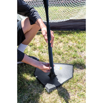 Person adjusts a portable soccer goal on grass field in an outdoor setting