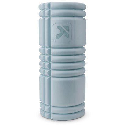A light gray foam roller rests upright against a plain white background