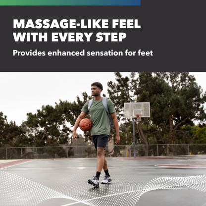 A man walks on a basketball court carrying a ball, promoting massage-like foot sensation.