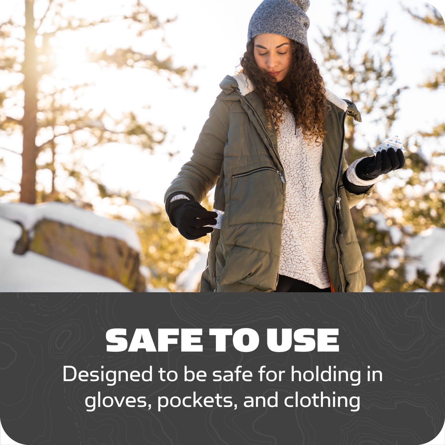 Woman outdoors checks gloves in winter environment at sunrise or sunset