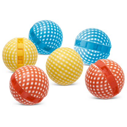 Colorful plastic balls with checkered patterns are scattered on a white background.