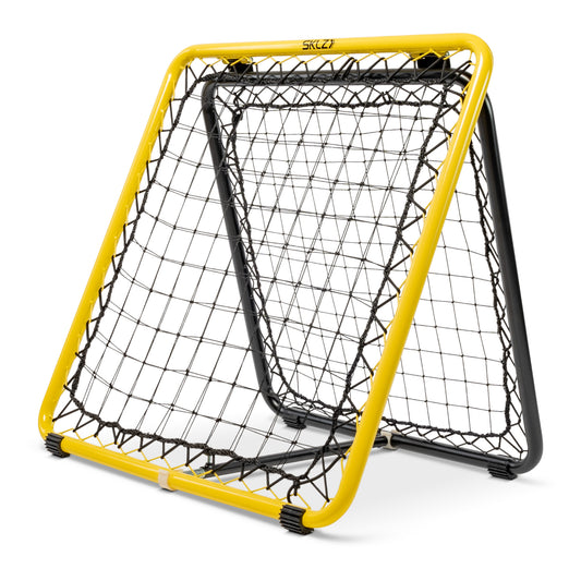 The goal frame is set up in an indoor sports area for practicing hockey skills.