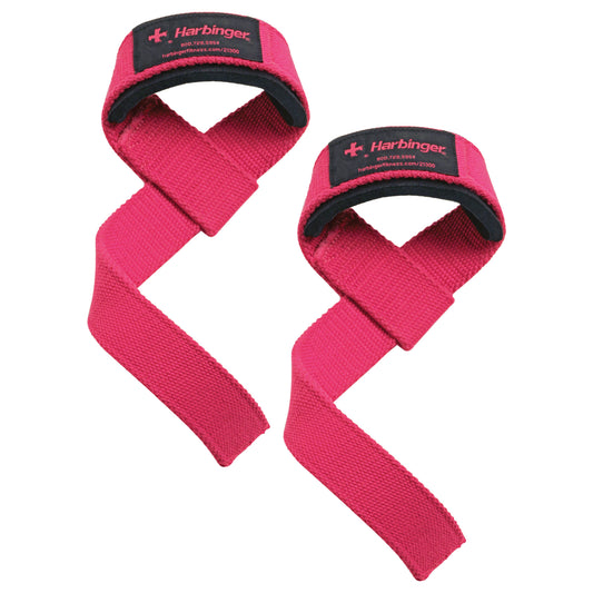 Two pink wrist straps secure hands during exercises in a gym environment