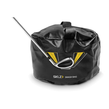 A smash bag with a golf club inside placed on a plain surface for storage or transport