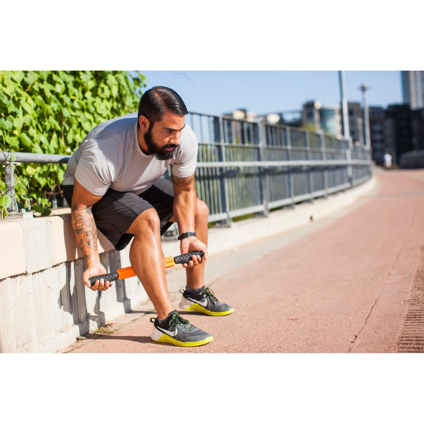 Man performs tricep dips on curb in an urban outdoor setting