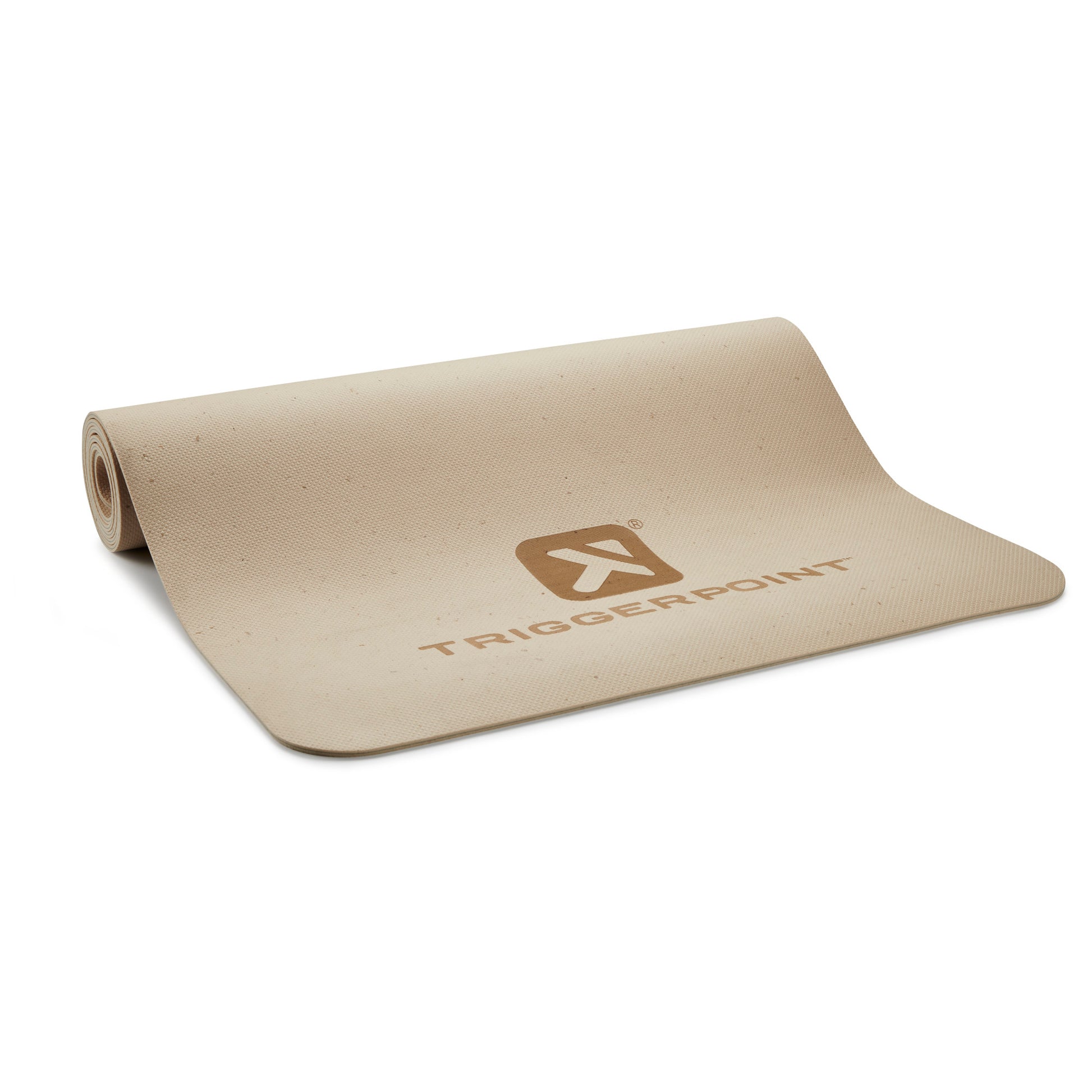 A beige yoga mat with a Tiggerpoint logo lies partially rolled on a white surface