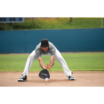 Baseball player reaches for ball on field during practice or game session