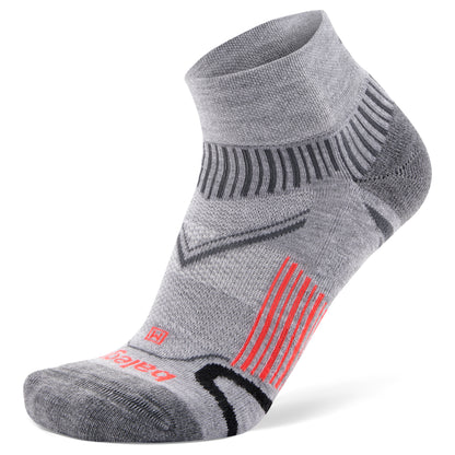 A gray athletic sock displays red and black stripes on a white background with brand markings