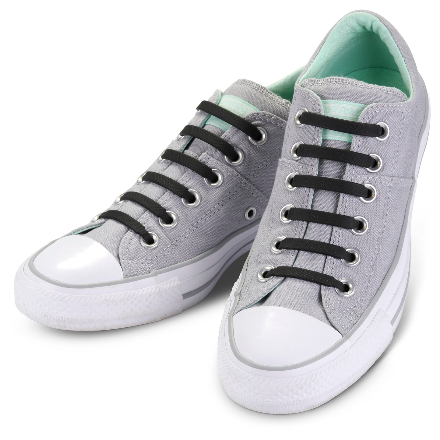 Gray sneakers with black laces are displayed on a white surface.