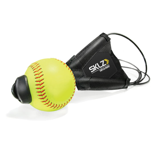 A baseball with a training sensor attached resting on a white surface