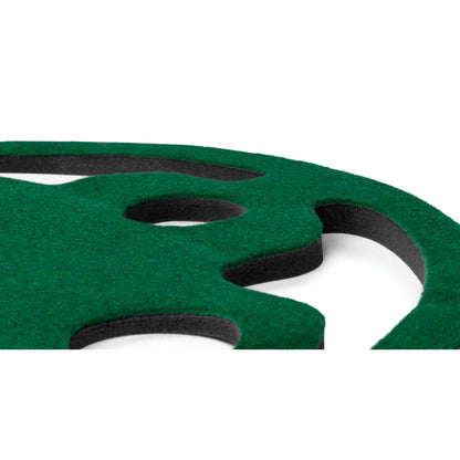 A green foam cutout with black inner layers rests on a white background