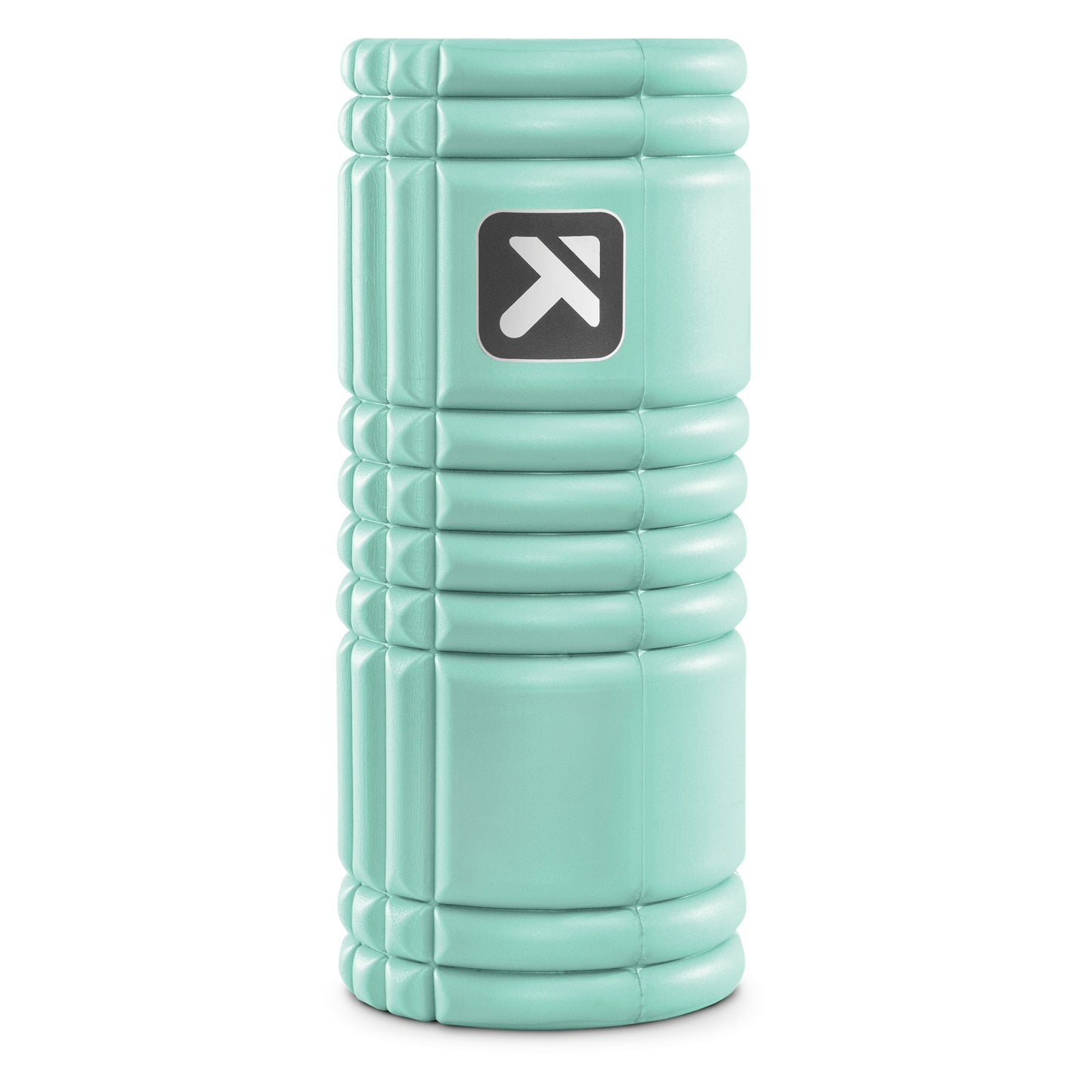 A teal foam roller stands upright in a studio setting.