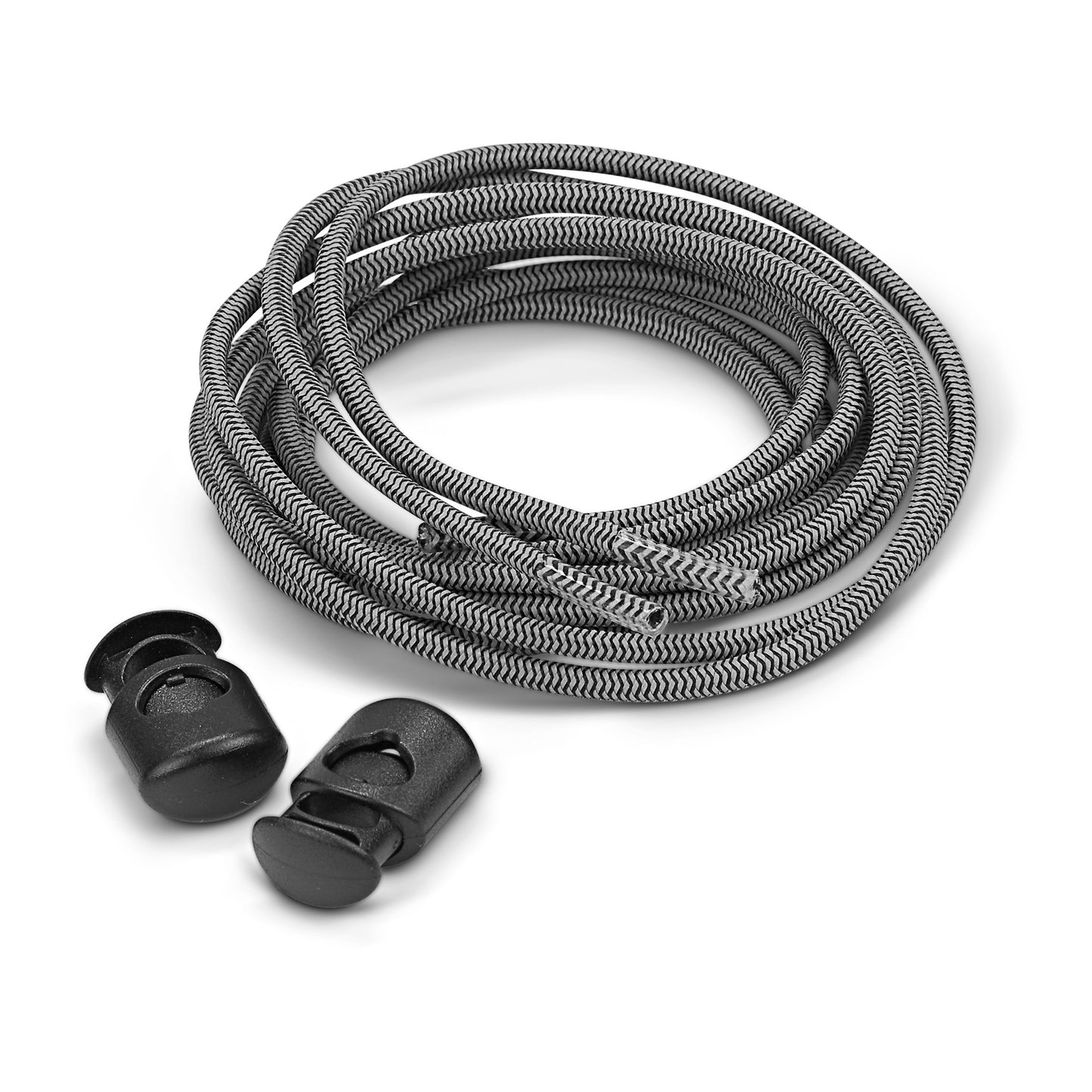 The shoelace is coiled with two plastic aglets nearby on a white surface.