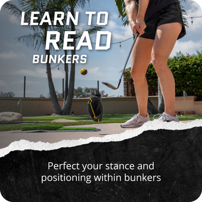 Person practicing golf stance and positioning in outdoor surroundings with bunkers