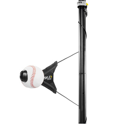 A baseball is attached to a pitching machine mounted on a vertical pole in a practice area