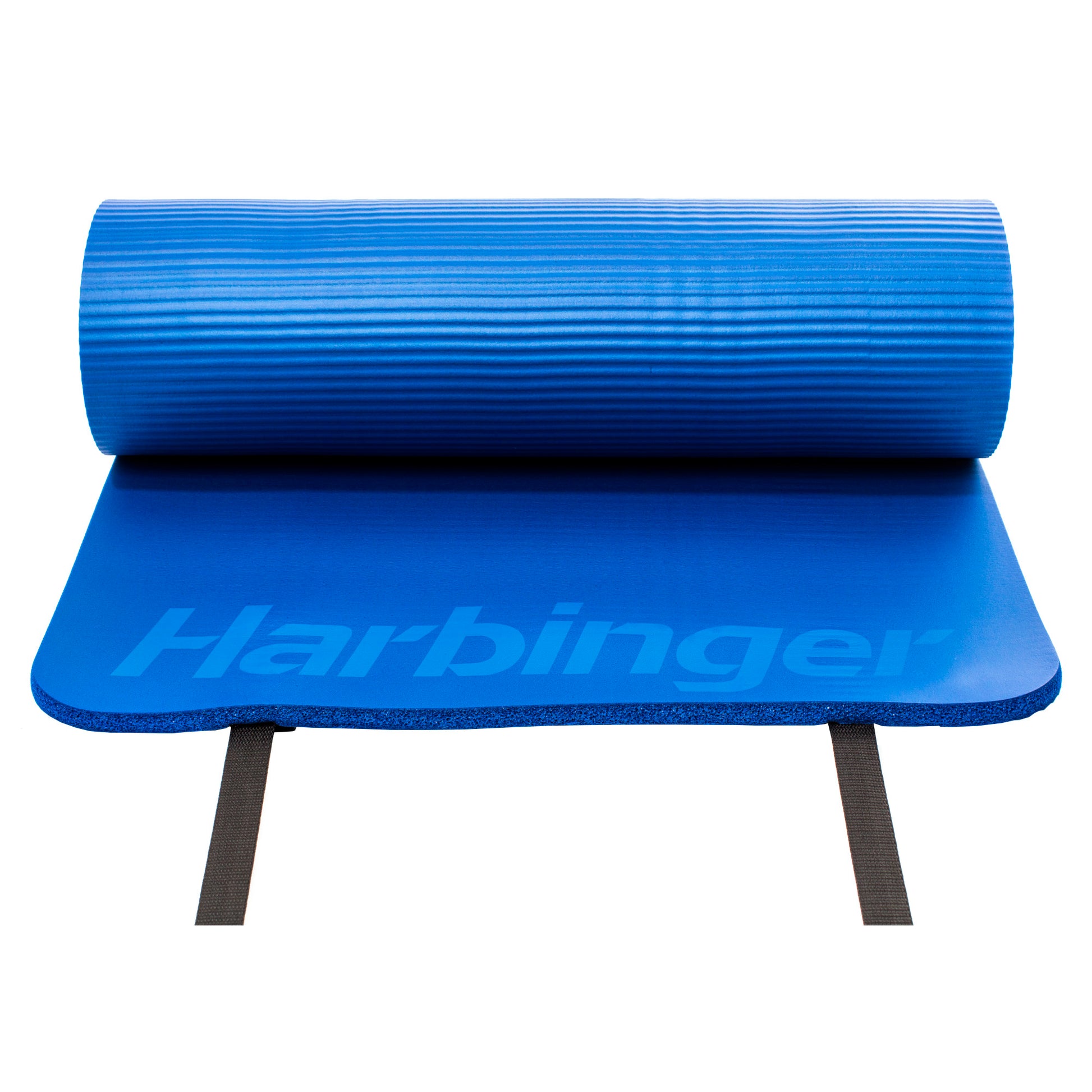 A blue exercise mat with a rolled section on top and black supporting straps in a studio environment.