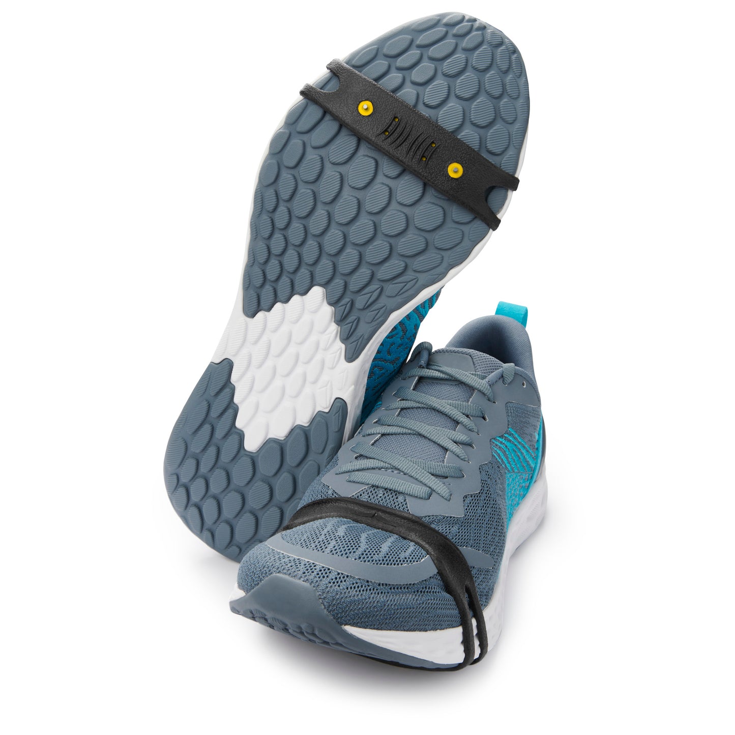 Sneaker moves with grip strap on sole, in a retail display environment.