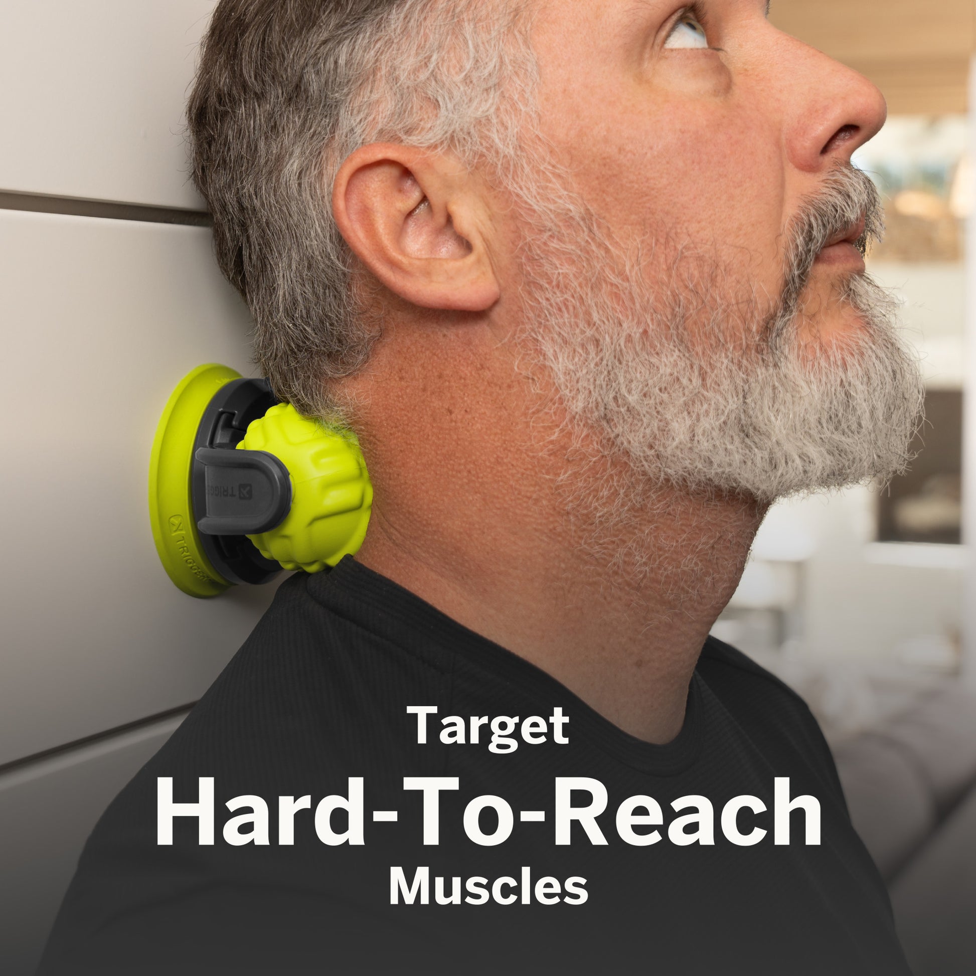 Neck muscle trainer performs exercise on man against light-colored wall at home