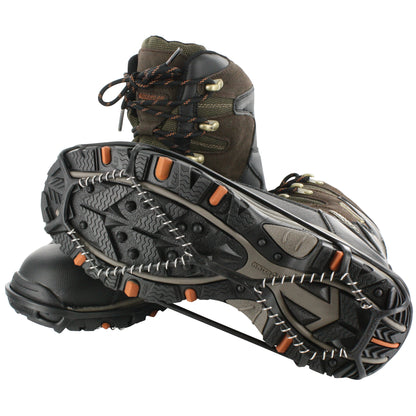 A hiking boot is displayed with a snow chain wrapped around the sole in a neutral environment.