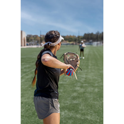Girl practicing softball in a field during daytime