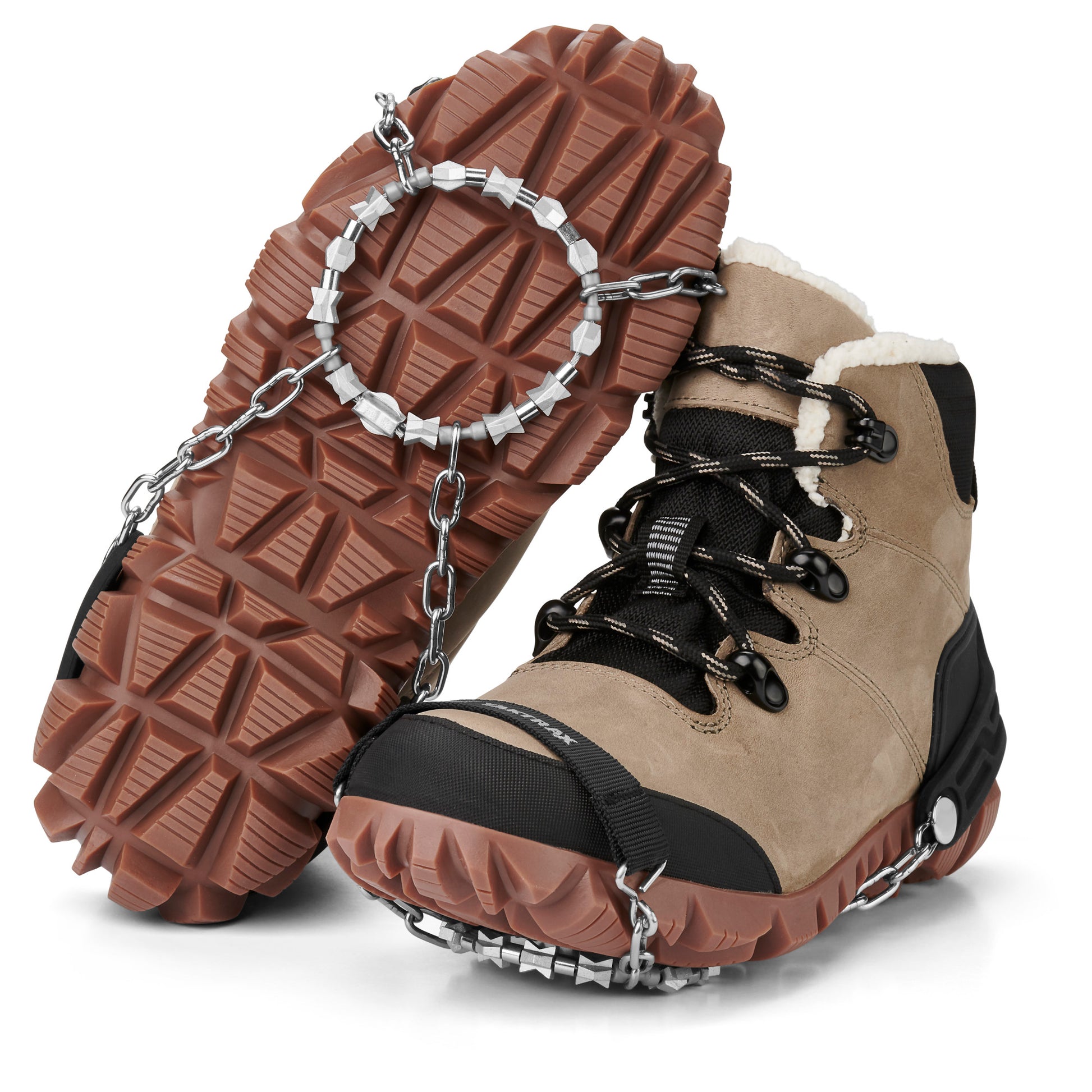 Hiking boots are fitted with snow chains for traction on icy terrain.