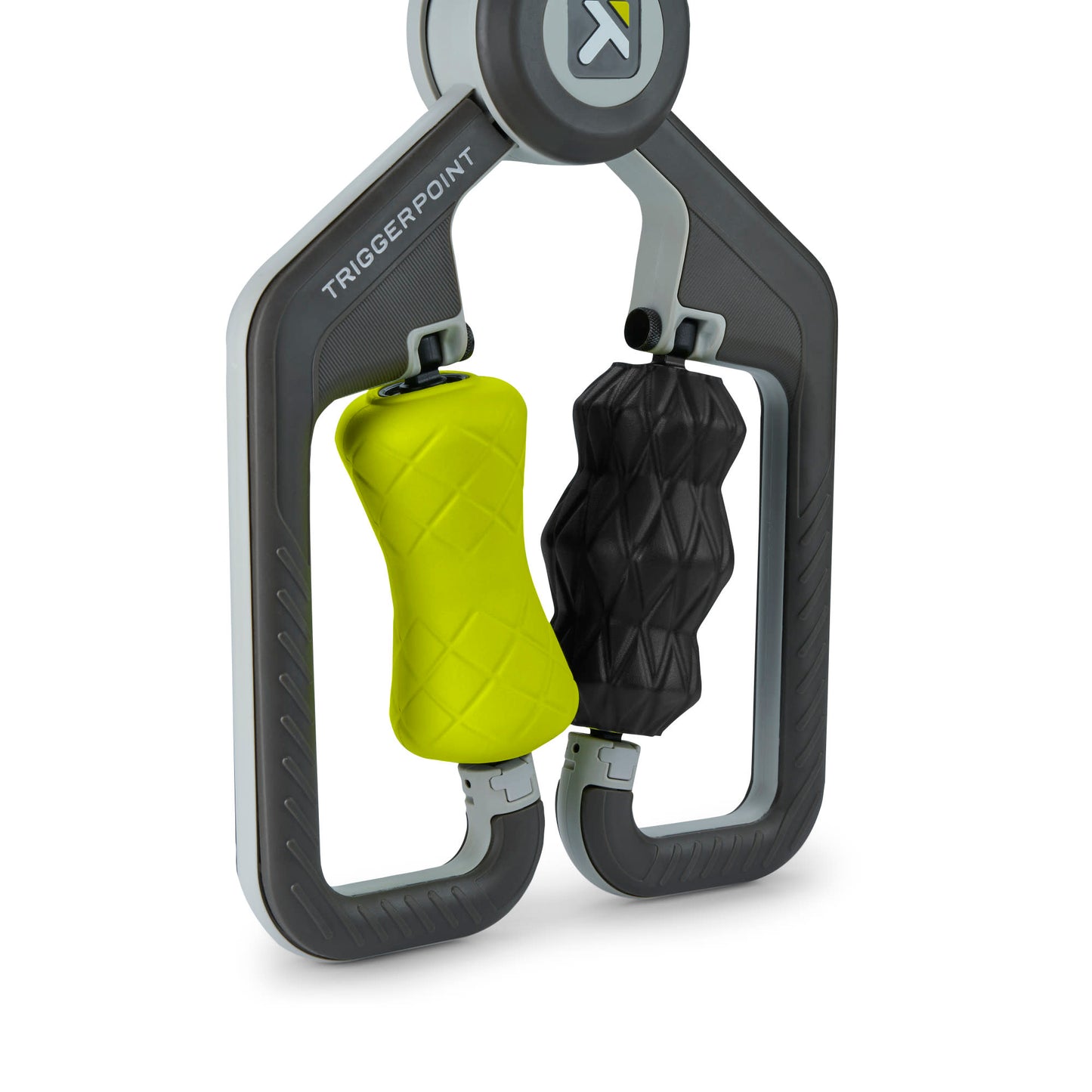 A carabiner clip holds two weighted grips for exercise in a fitness environment.