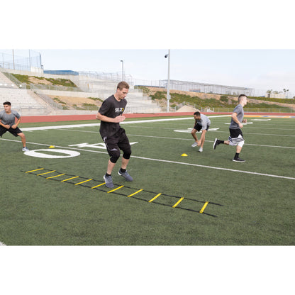 Athletes perform agility drills on a football field during training session outdoors