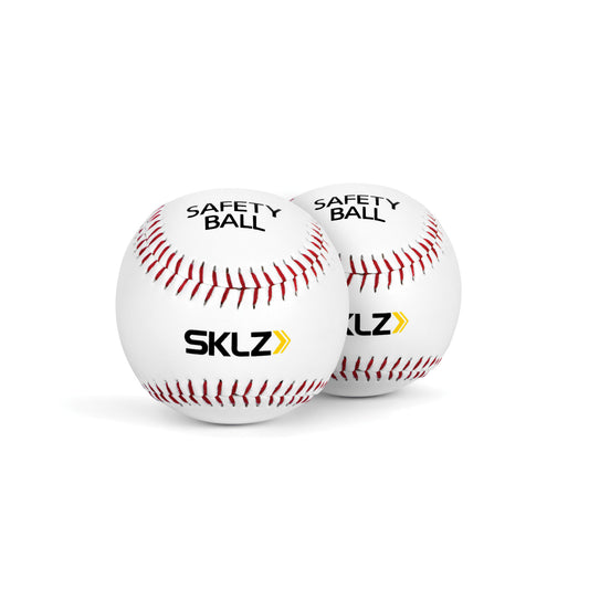 Two safety baseballs labeled SKLZ rest on a white surface with a plain white background