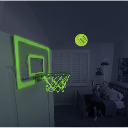 Child shoots a ball towards a glowing basketball hoop in a bedroom