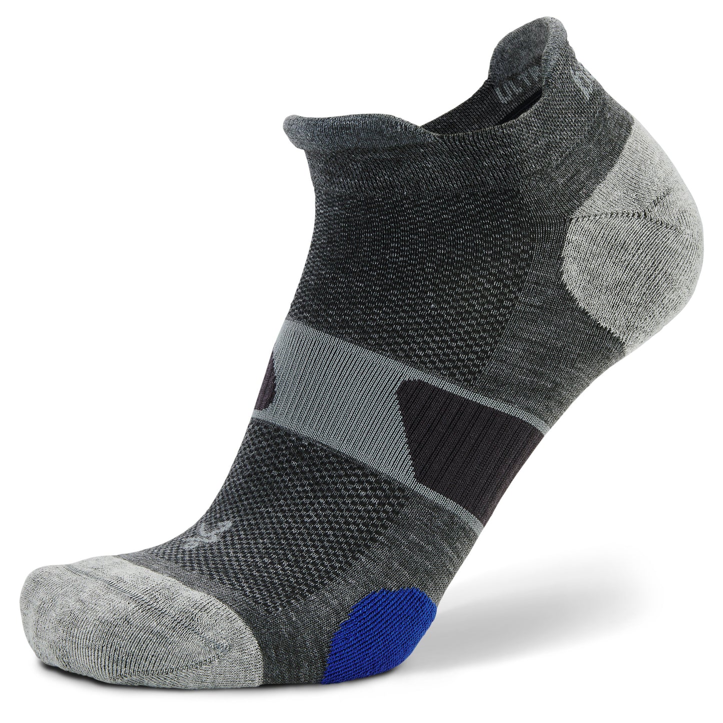 A sock stretches over a foot form in a retail setting or studio showcasing its design.