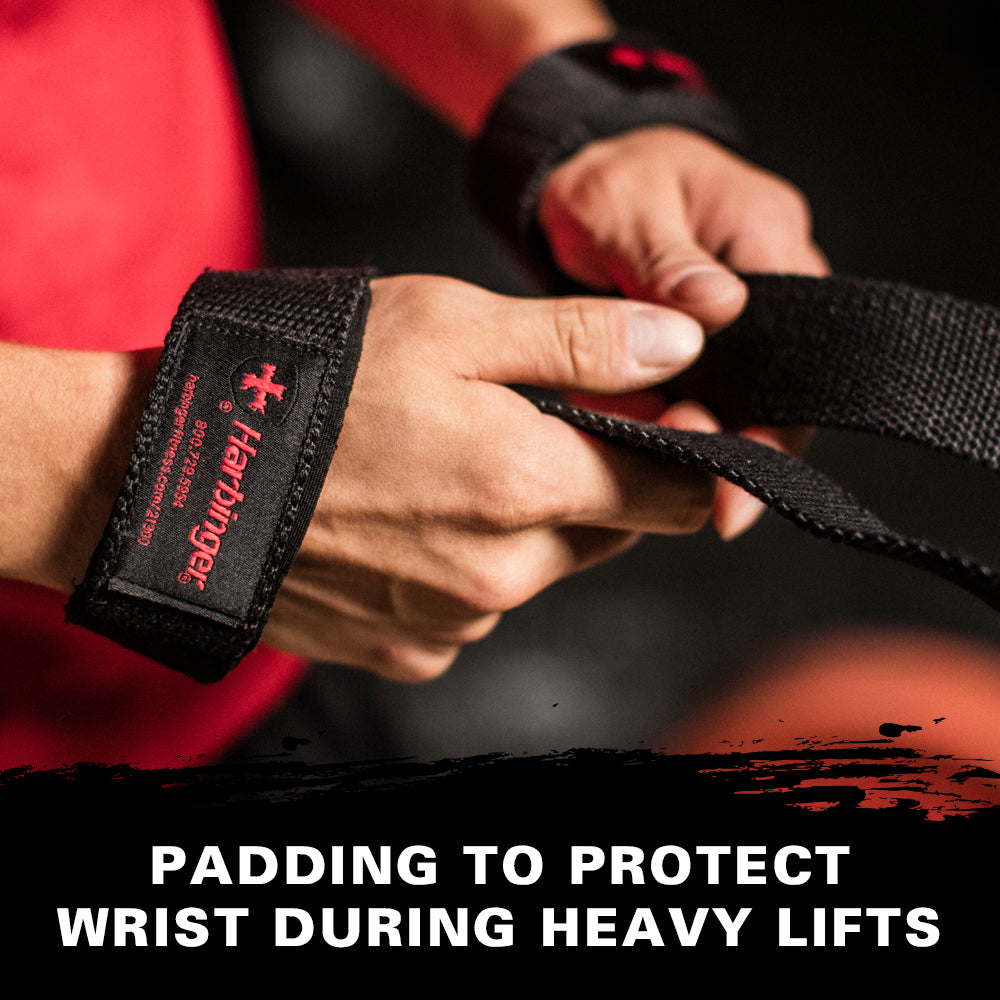 Hands adjust wrist straps for protection during heavy lifts in a gym setting
