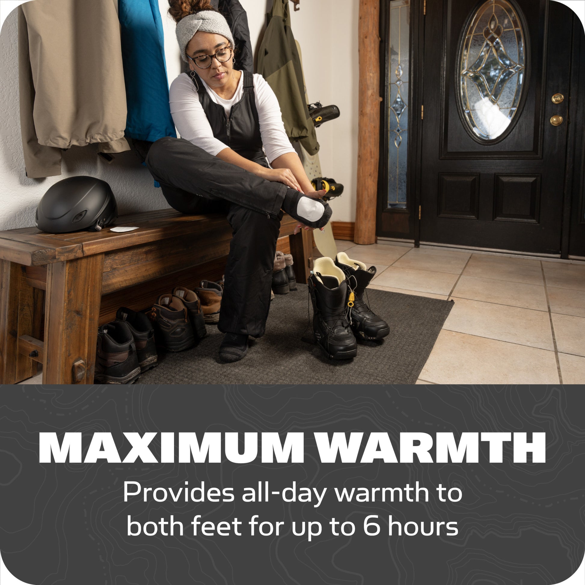 Person puts on winter boots in entryway for maximum warmth up to six hours.