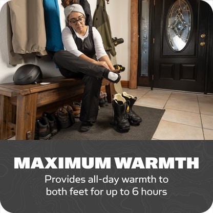 Person puts on winter boots in entryway for maximum warmth up to six hours.