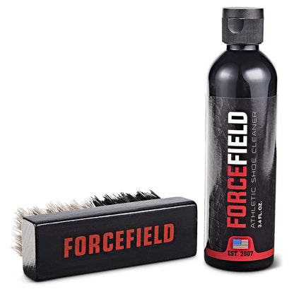 A shoe cleaner spray and brush clean footwear in a white environment.