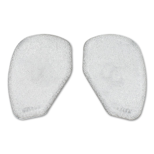 Two white foam pads used for skincare or facial cleansing in a white environment.