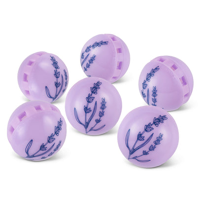Six purple massage balls with blue lavender flower designs lie scattered on a white surface.
