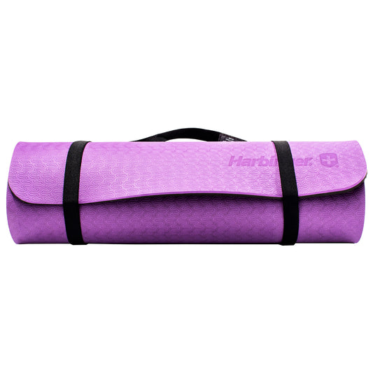 Yoga mat is rolled up and secured with black straps against a plain background.