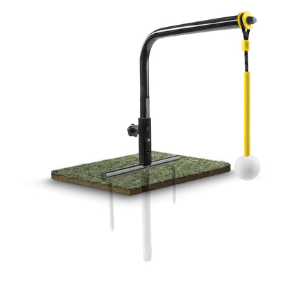 A golf training aid swings a golf ball on a tee to a goal on a turf surface