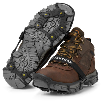 Work boots with crampons attached for traction in icy terrain