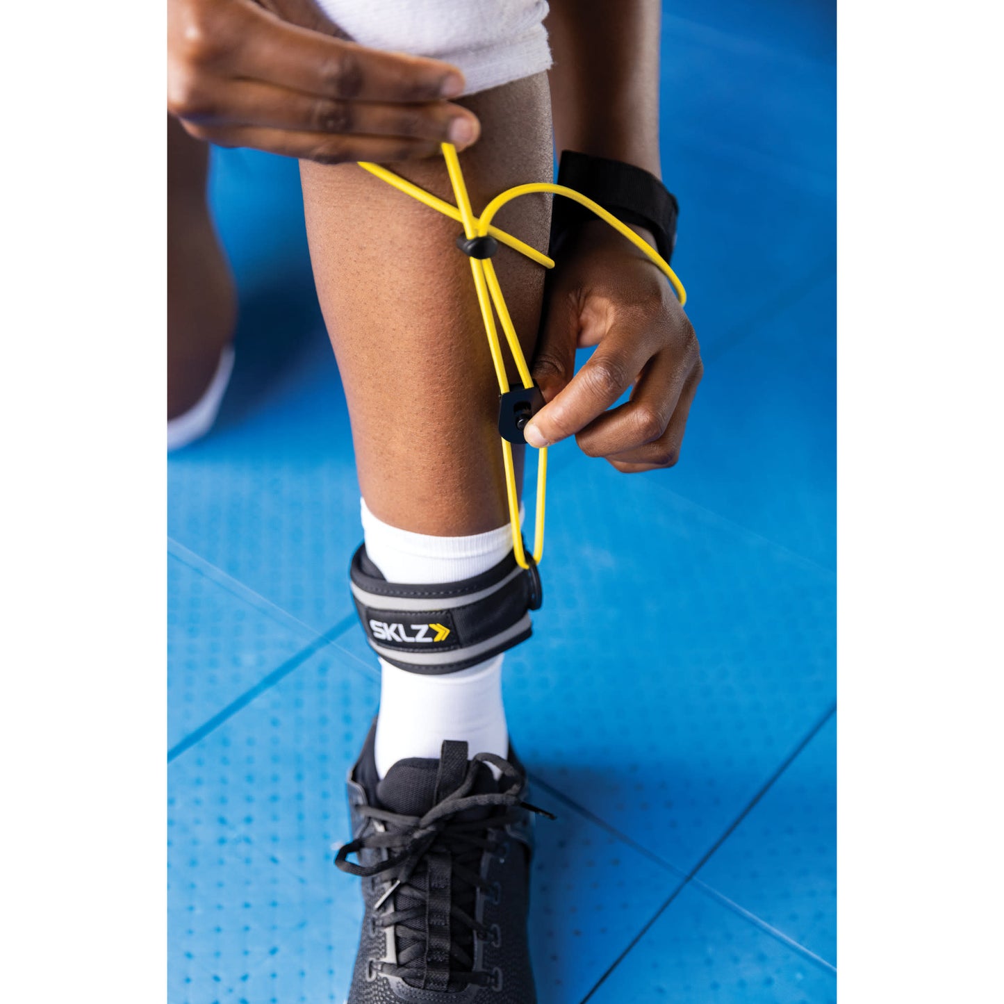 Close-up showing adjustability of SKLZ Bump and Pass Trainer in gym