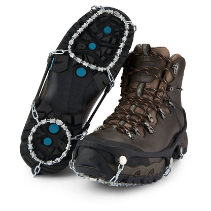 Hiking boots are fitted with metal chains for traction on icy surfaces.