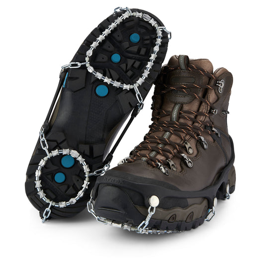 Hiking boots are fitted with metal chains for traction on icy surfaces.