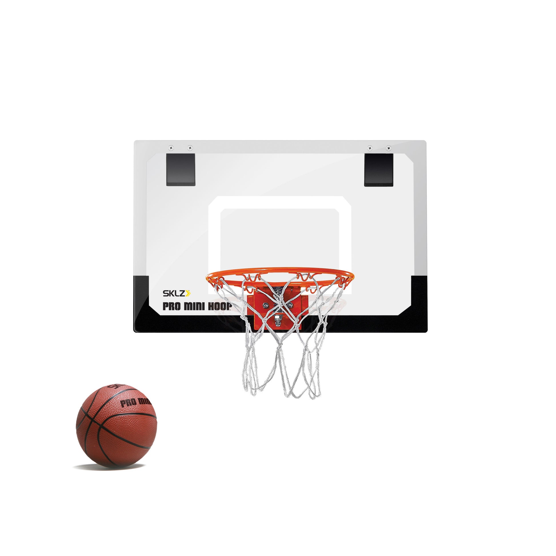 A basketball bounces next to a mini hoop mounted on a wall in a plain environment