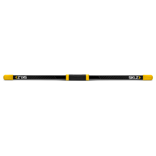 The ski pole spans horizontally with yellow end caps in an empty space.