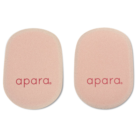 Two round pink makeup sponges with the brand name apa printed on them, isolated on a white background.