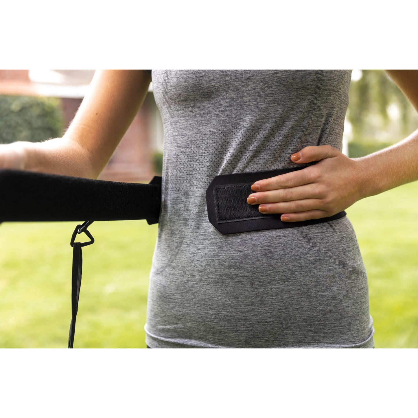 Person wears a weighted vest outdoors for exercise or training