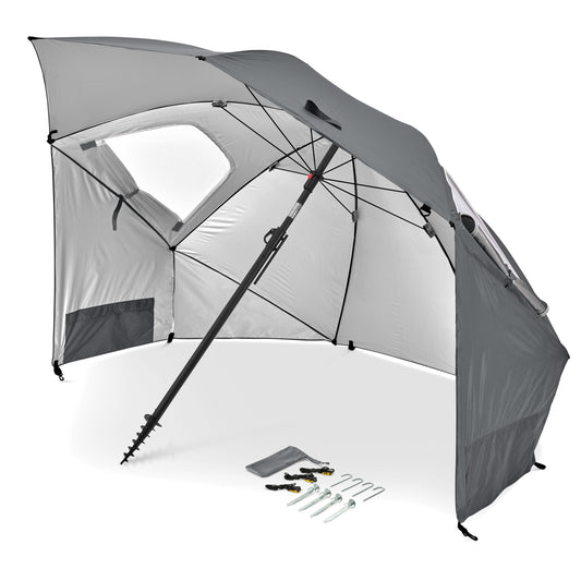 An outdoor beach tent with a built-in umbrella provides shade on a sunny day.