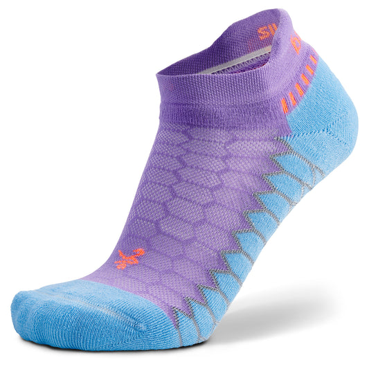 The sock features a honeycomb pattern with zigzag accents in a sportswear setting.